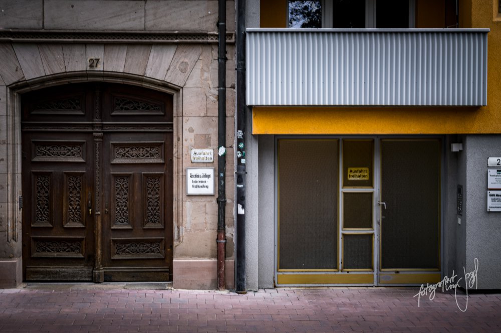 Holzportal neben gelber Fassade