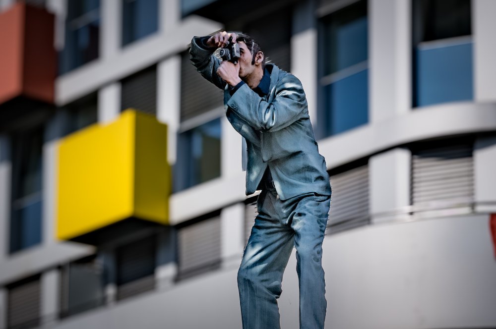 Säulenheilige: Der FotografFotografierende Figur